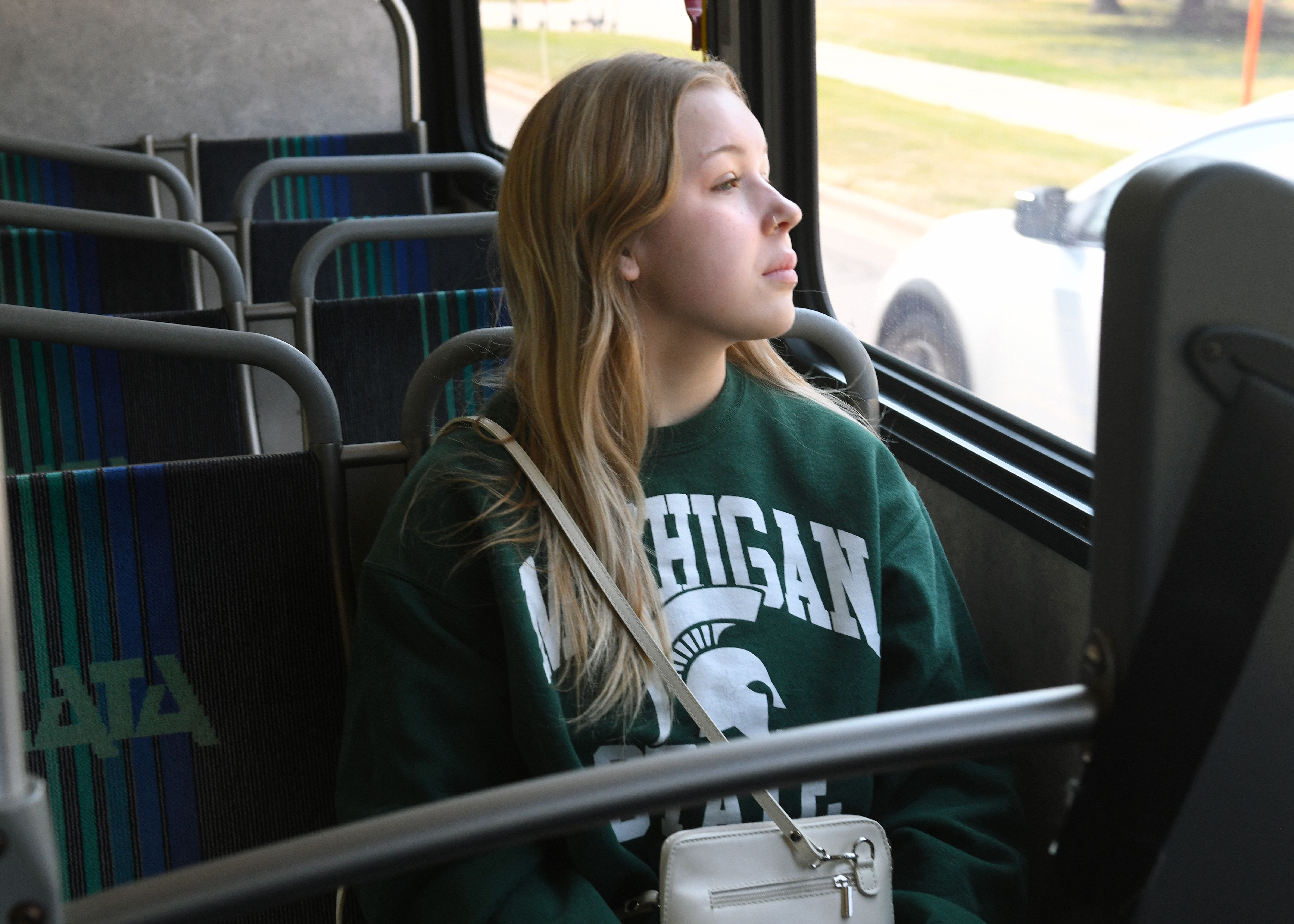 MSU student sitting on a bus