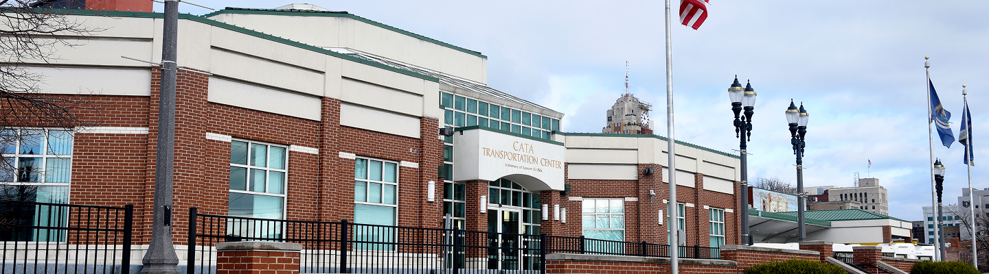 CATA Transportation Center building exterior with flagpoles and street lamps.