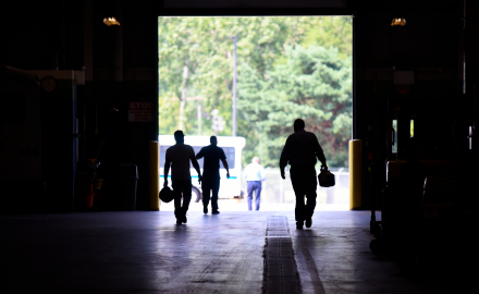 CATA employees walking through the CATA bus storage facility