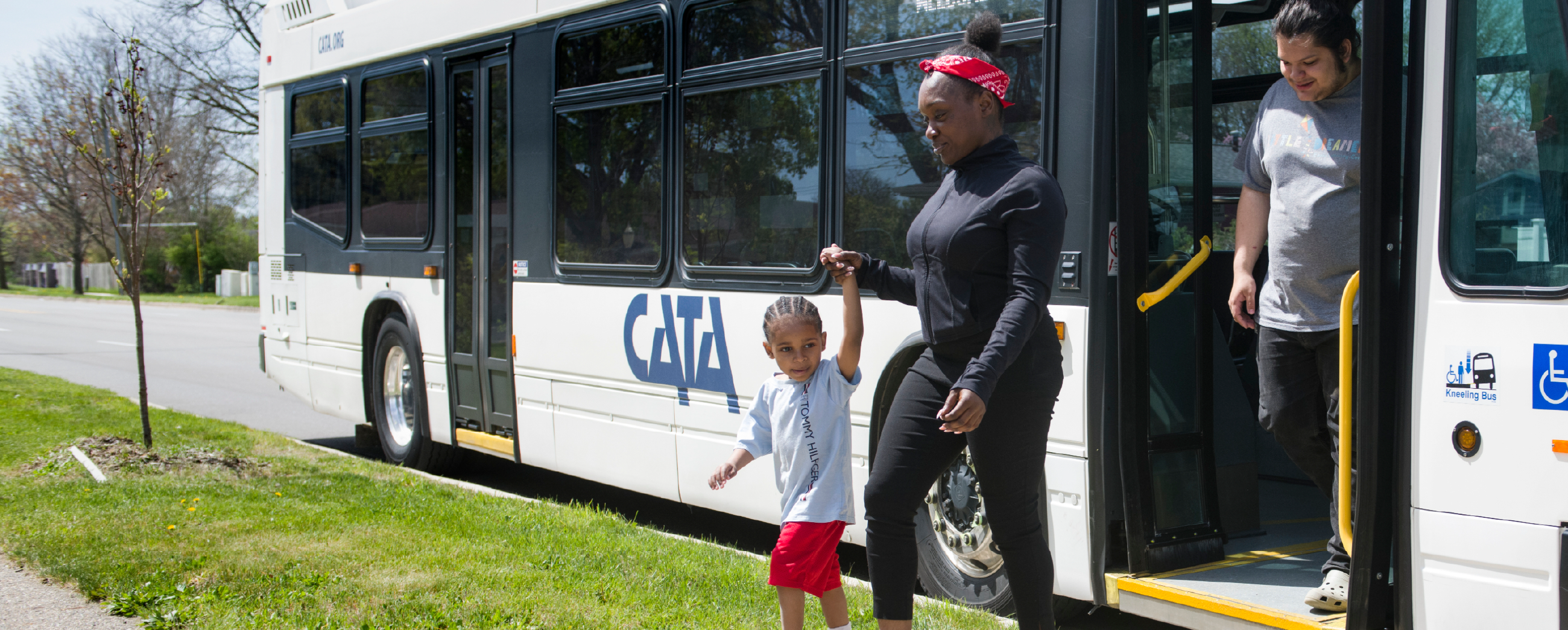 A white CATA bus on a city road, displaying '3 MARKETPLACE' on its destination sign, surrounded by other vehicles.