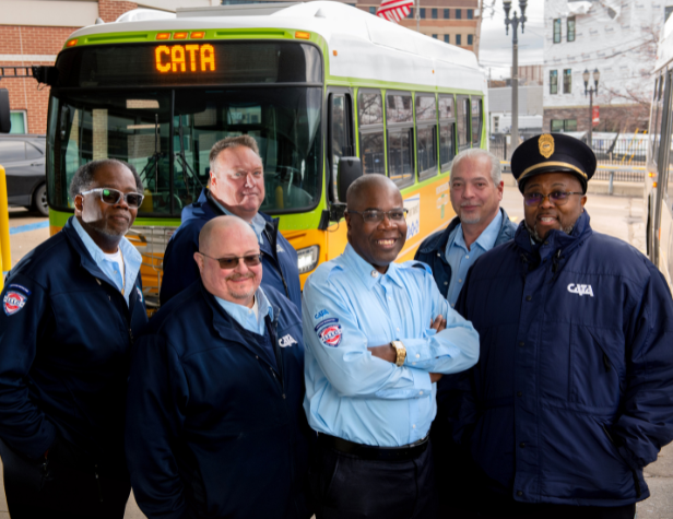 CATA drivers in front of a bus