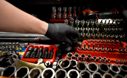 Mechanic hand reaching near tools 