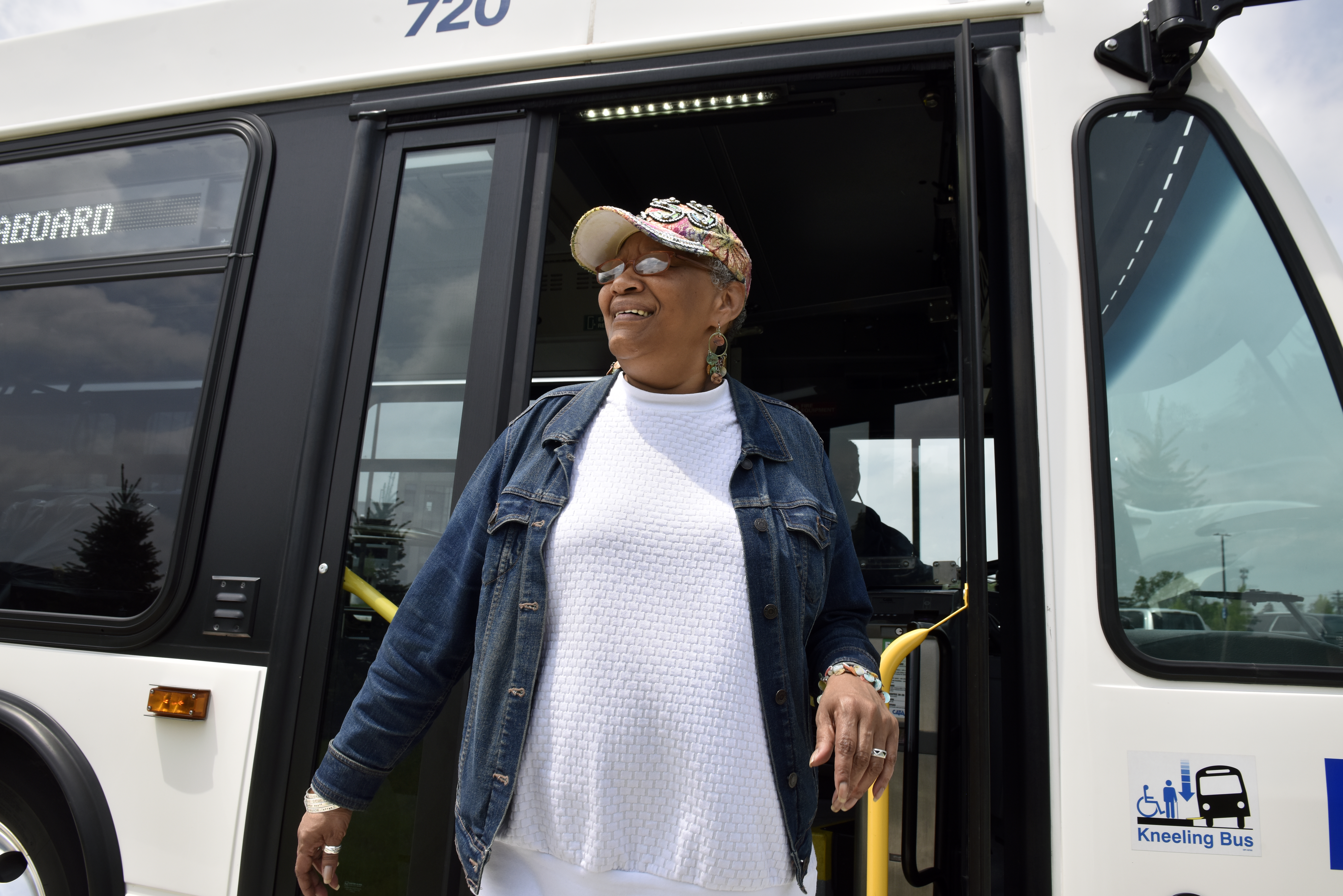 Photo of CATA Rider exciting bus and smiling