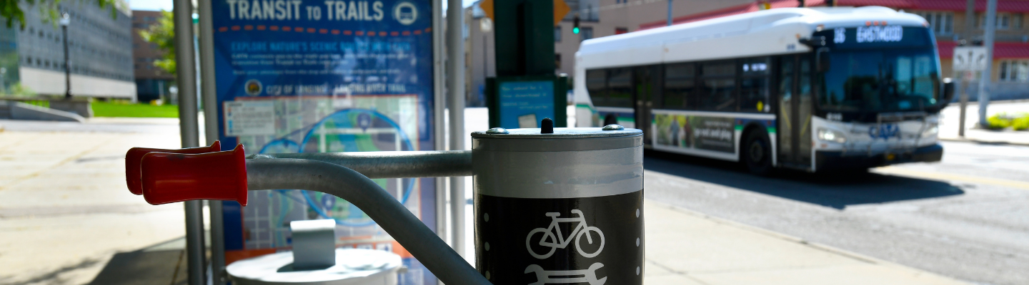 Bike repair station in front of a CATA Transit to Trails shelter and bus