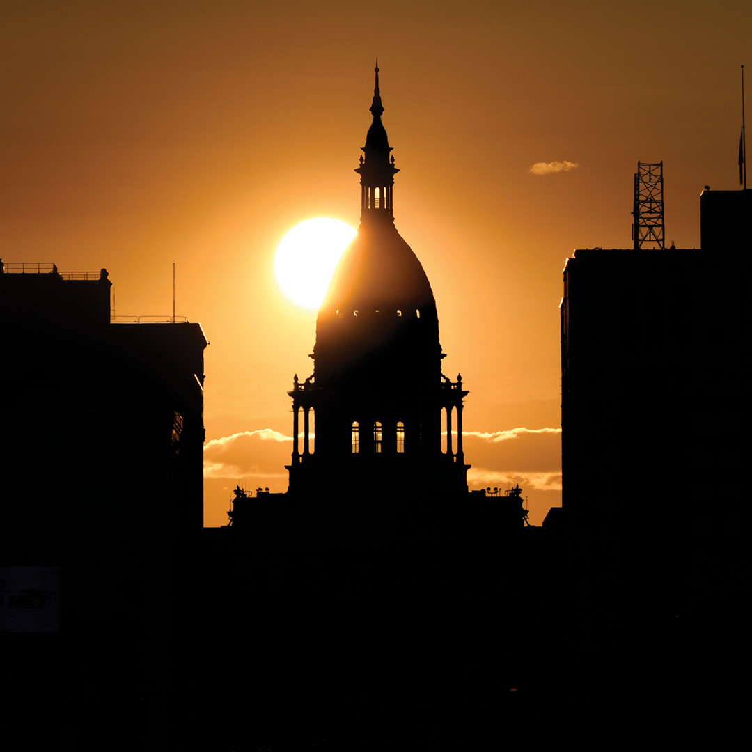 A sunset against the michigan capitol building 