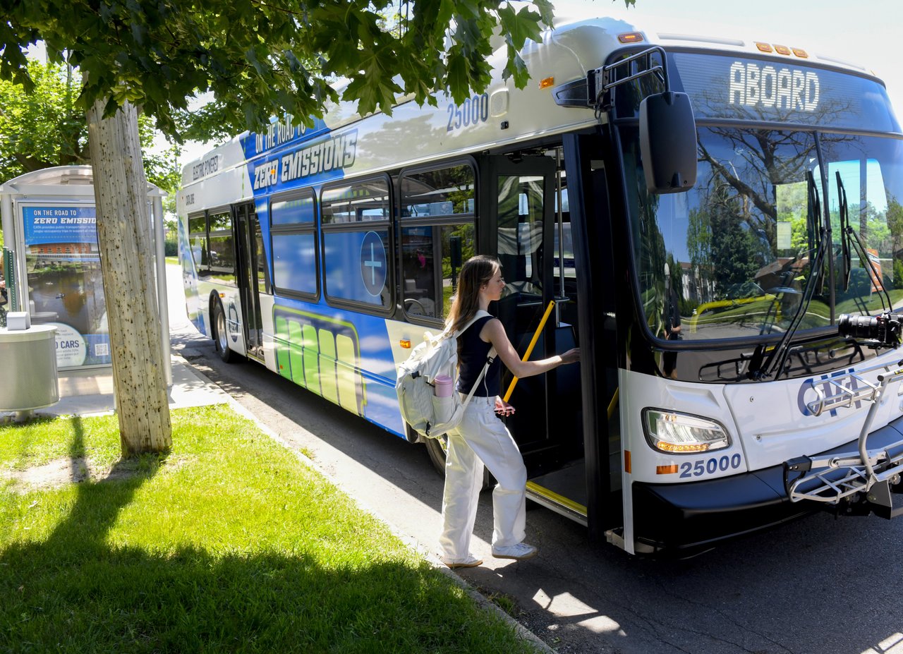 A rider boarding the New Flyer electric bus