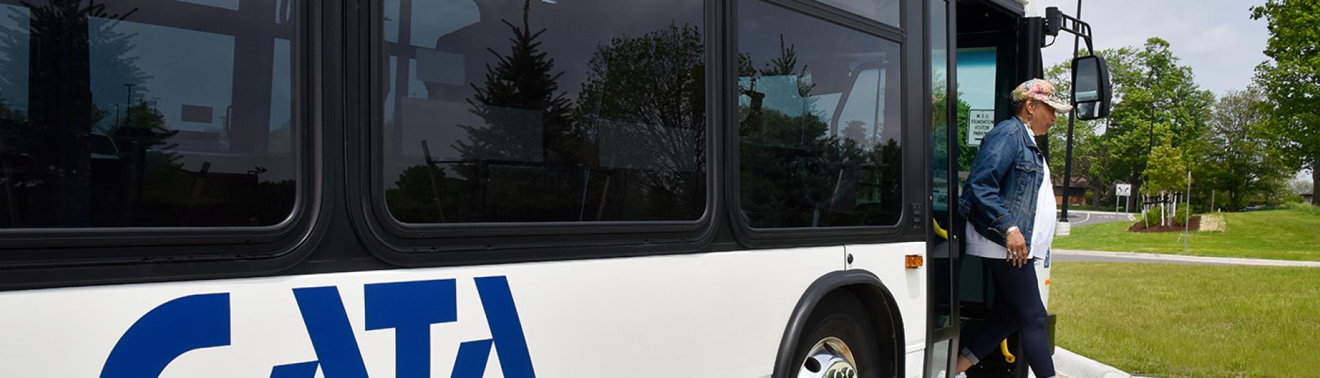 A woman exiting a CATA bus