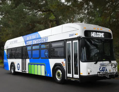 CATA's first full-sized electric bus. The bus has a wrap that says "On the road to zero emissions" with a graphic of a battery