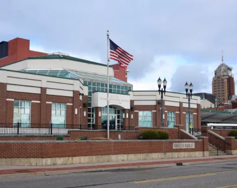 The outside of the CATA Transportation Center with an American flag flying in the wind