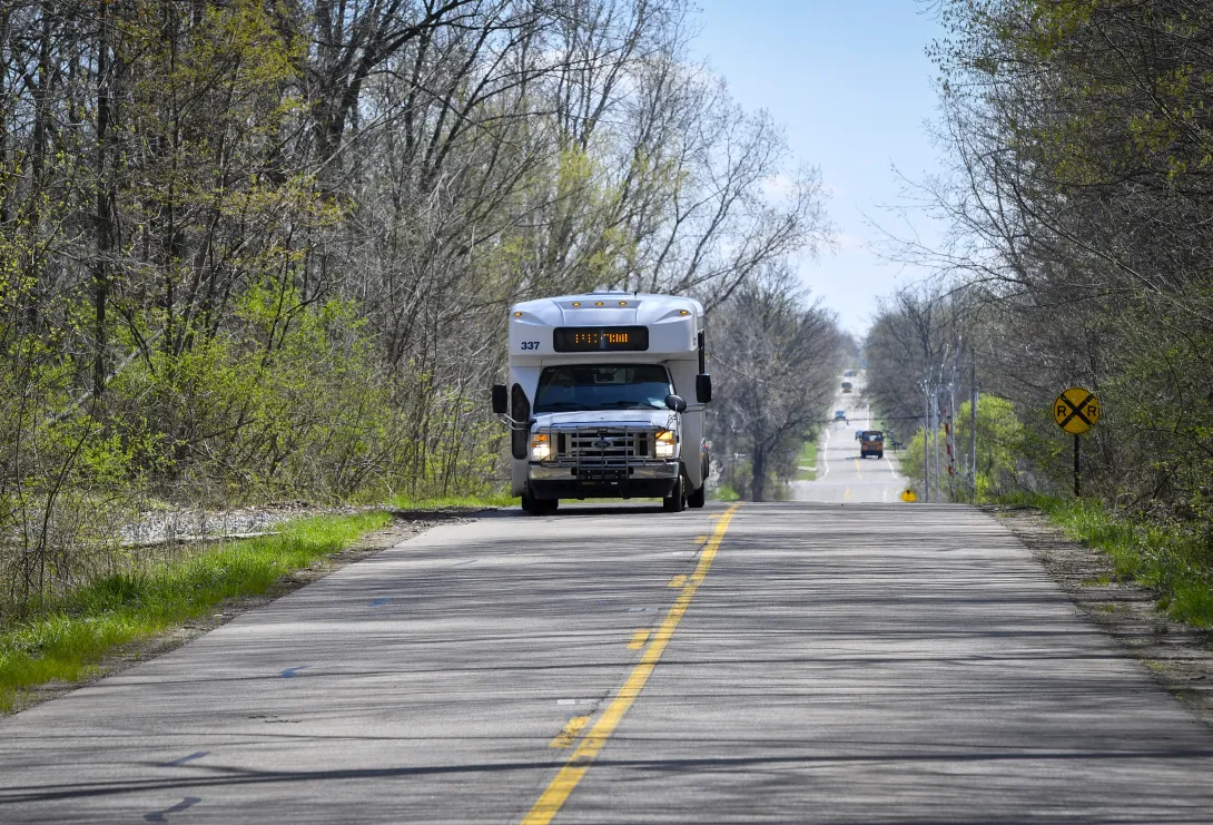 A CATA cutaway van driving down the road
