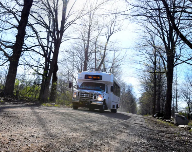 A CATA Rural Service Vehicle driving down a dirt road