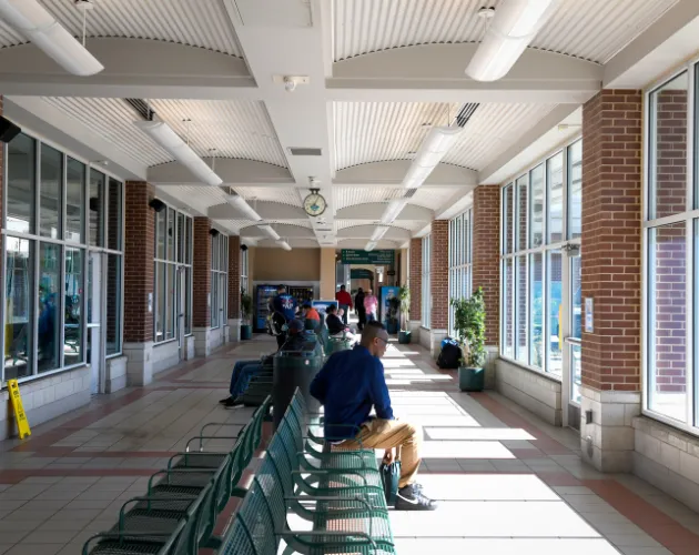 The inside of the CATA Transportation Center with people sitting on benches