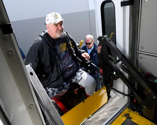 Lance Thomas boarding a Spec-Tran vehicle 