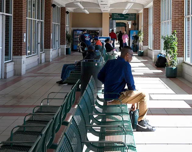 The inside of the CATA Transportation Center with riders on busses