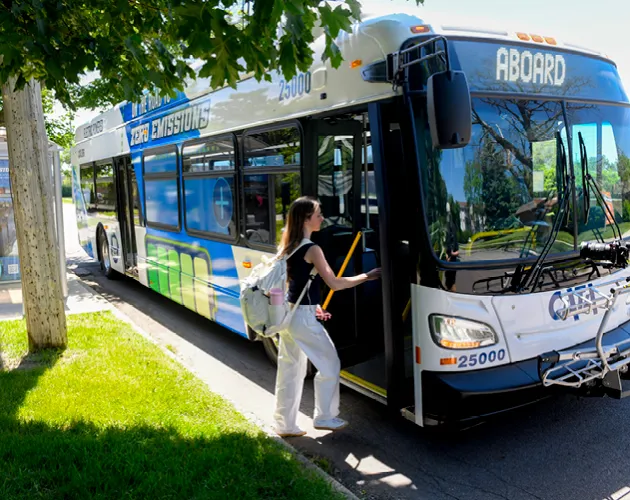 A person boarding CATA's electric bus