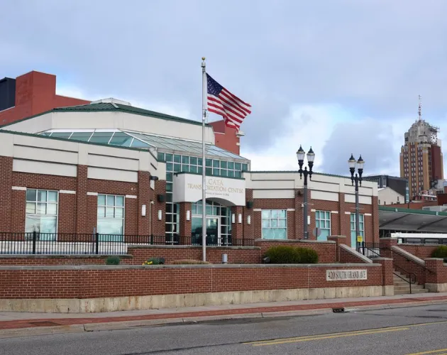 The outside of the CATA Transportation Center with an American flag flying in the wind